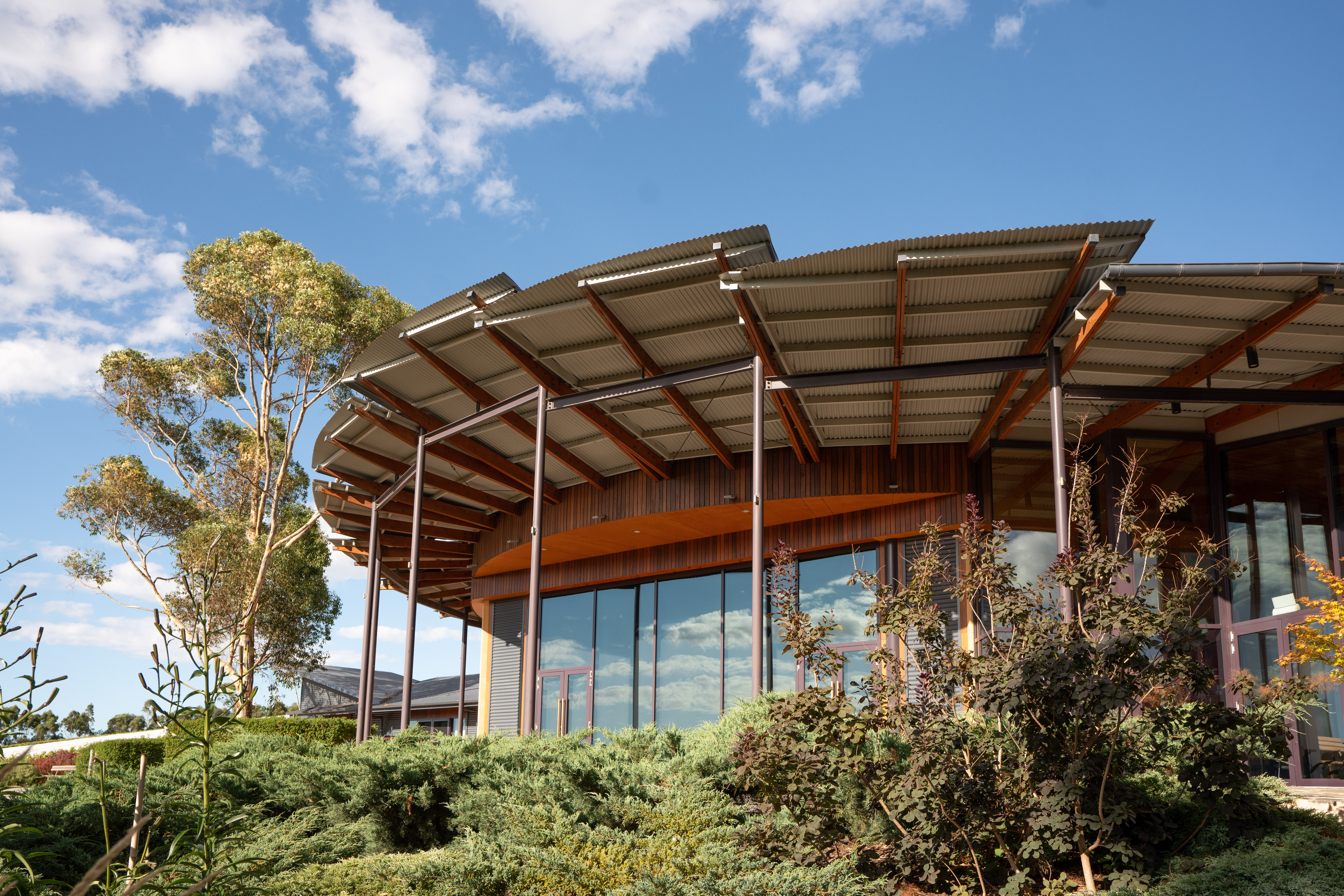 UKARIA Cultural Centre clad in LYSAGHT CUSTOM ORB® and CUSTOM ORB ACCENT® 21 shaped from COLORBOND® steel in Ironstone®